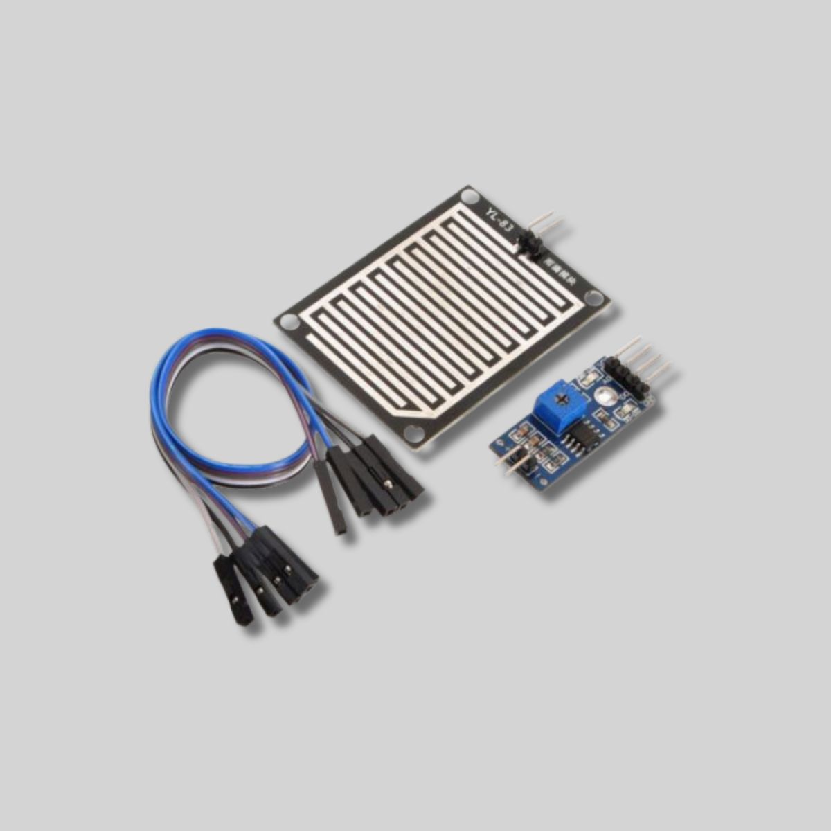Rain sensor module kit including the raindrop detection pad, control module, and jumper wires for Arduino projects.